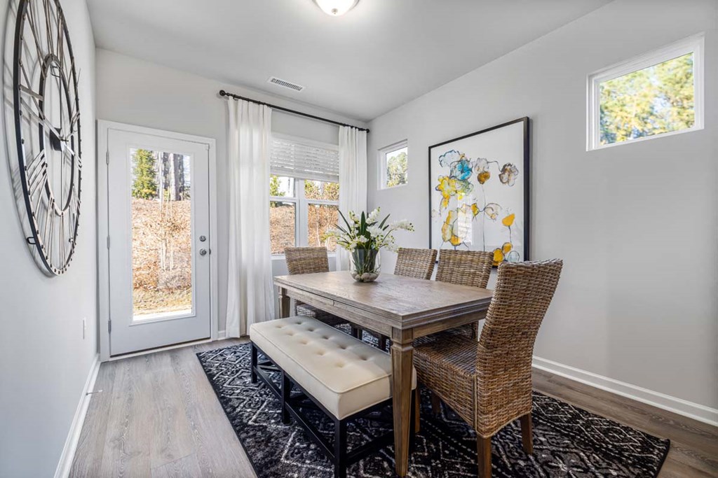 a dining room with a table and chairs and a door