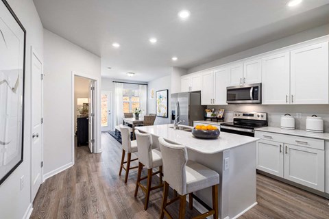 a kitchen with a large island with a counter top