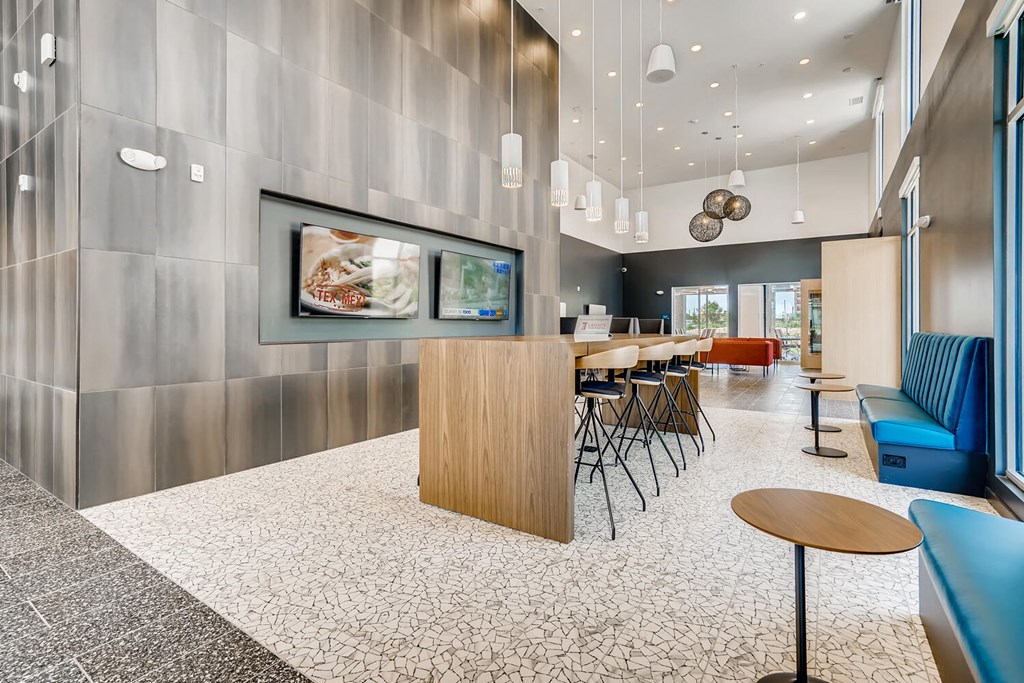 a lobby with a table and chairs and a tv