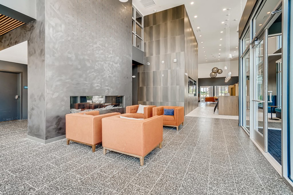 a large lobby with couches and a fireplace