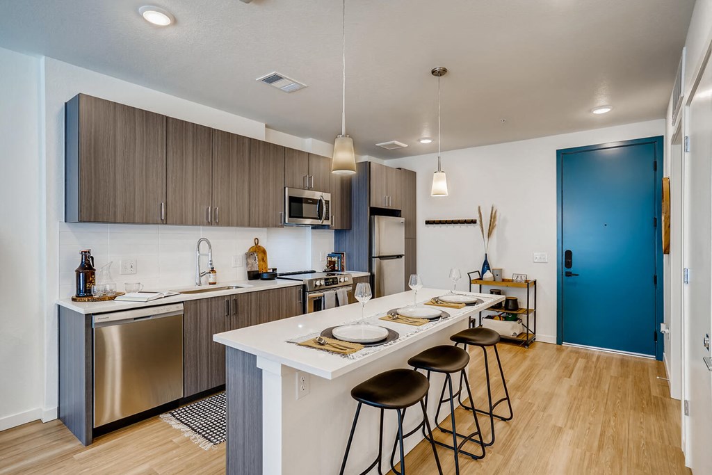 a kitchen with a long island with four stools