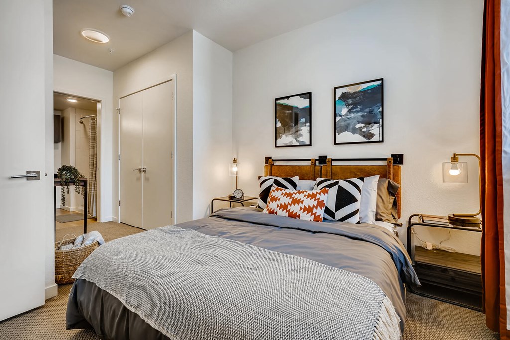 a bedroom with a bed and a door to a bathroom