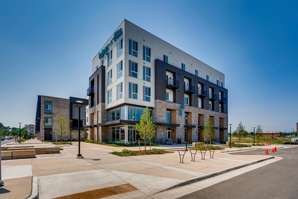 main view of the building with parking lot and street