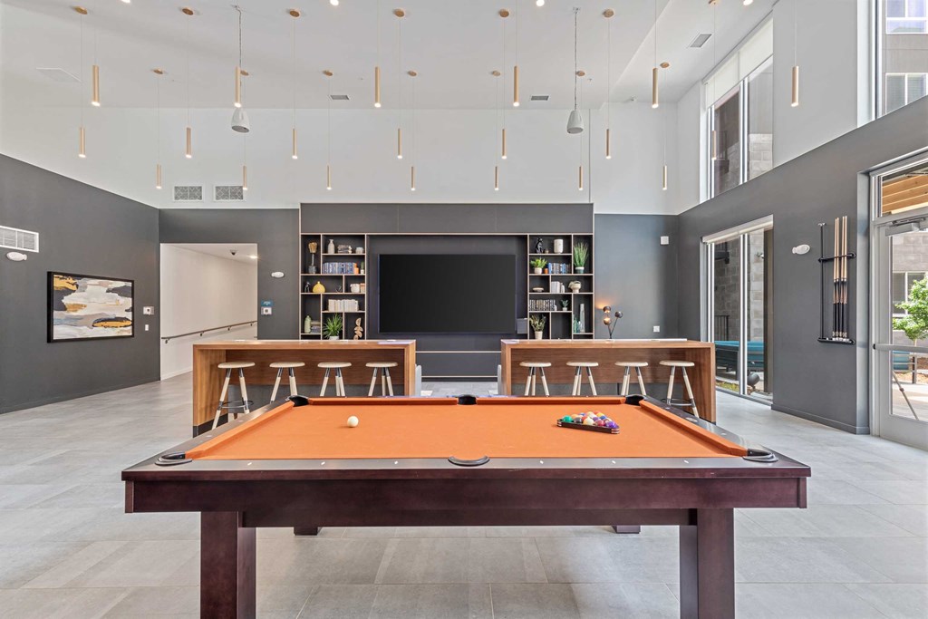 a games room with a pool table and a television