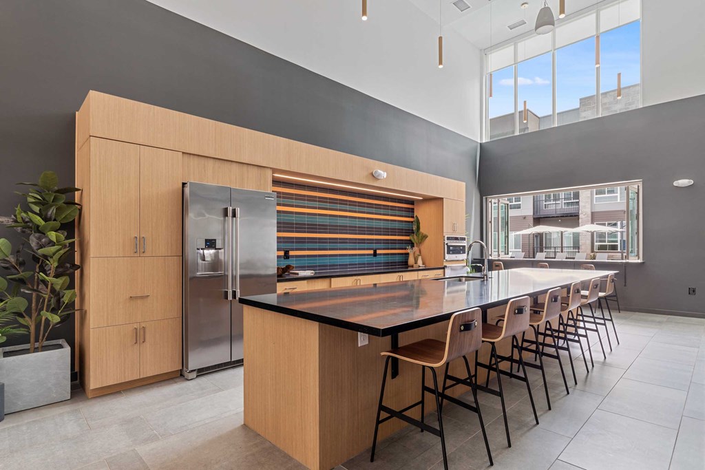 a large kitchen with a long island with chairs