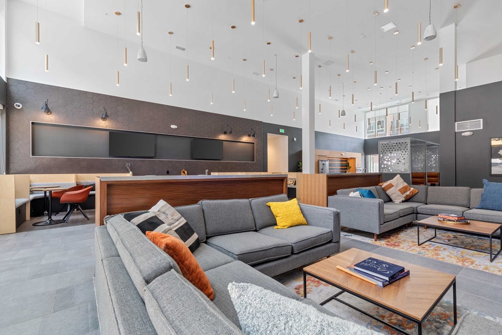 a lounge area with couches and chairs and a reception desk