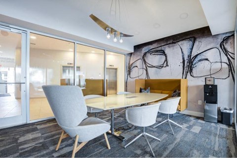 a conference room with a glass table and chairs