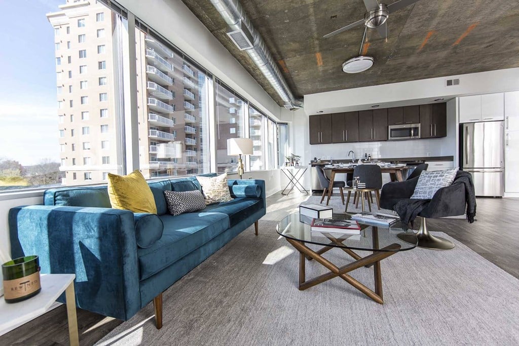 a living room with a blue couch and a table
