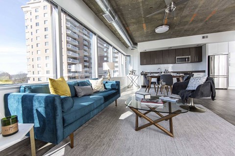a living room with a blue couch and a table