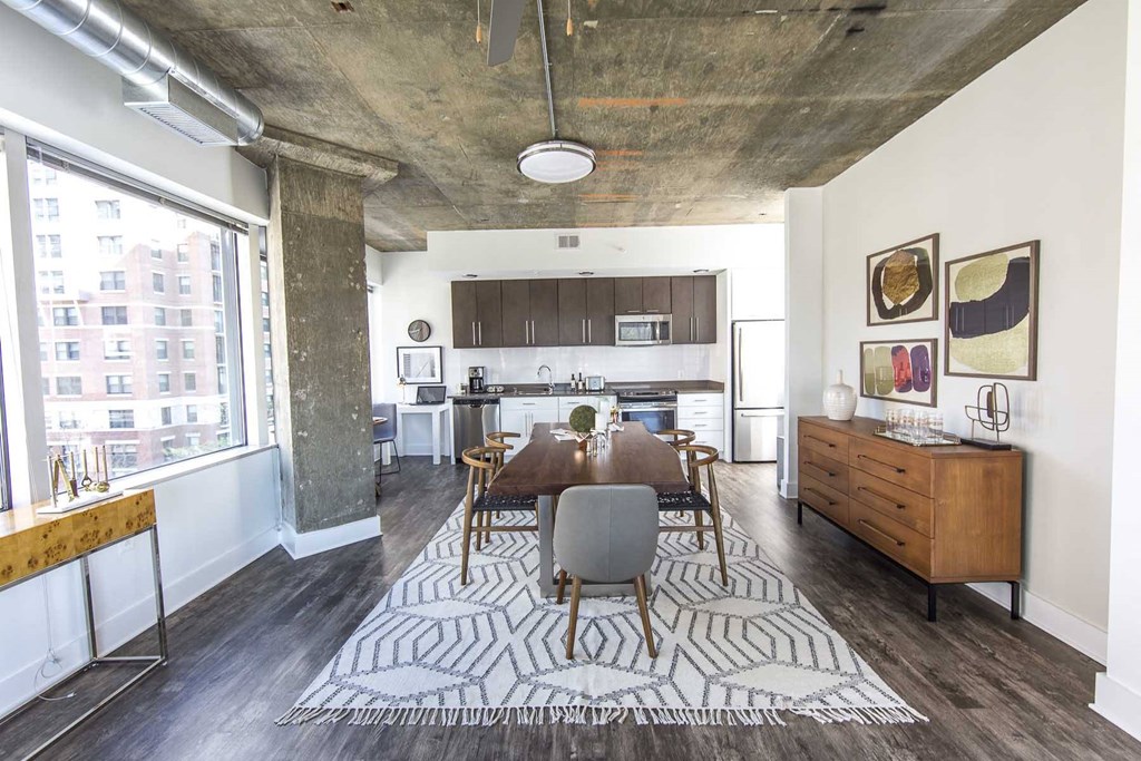 a dining room with a wooden table and a large rug