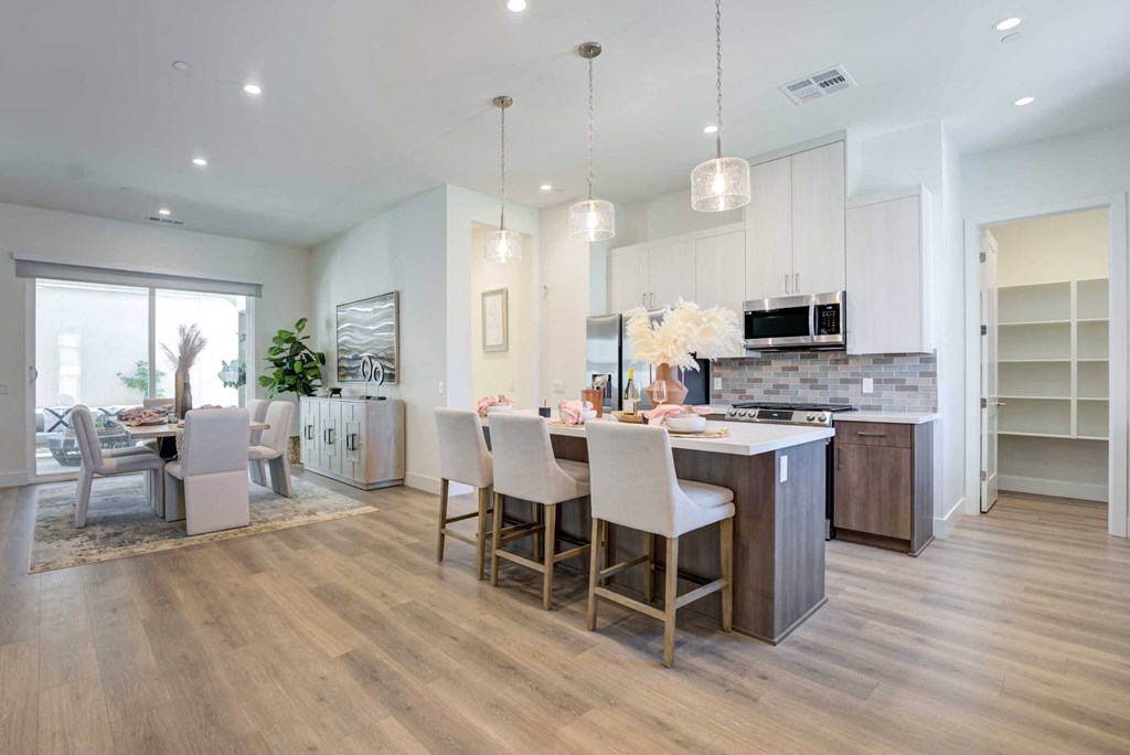 a kitchen and dining room with a table and chairs
