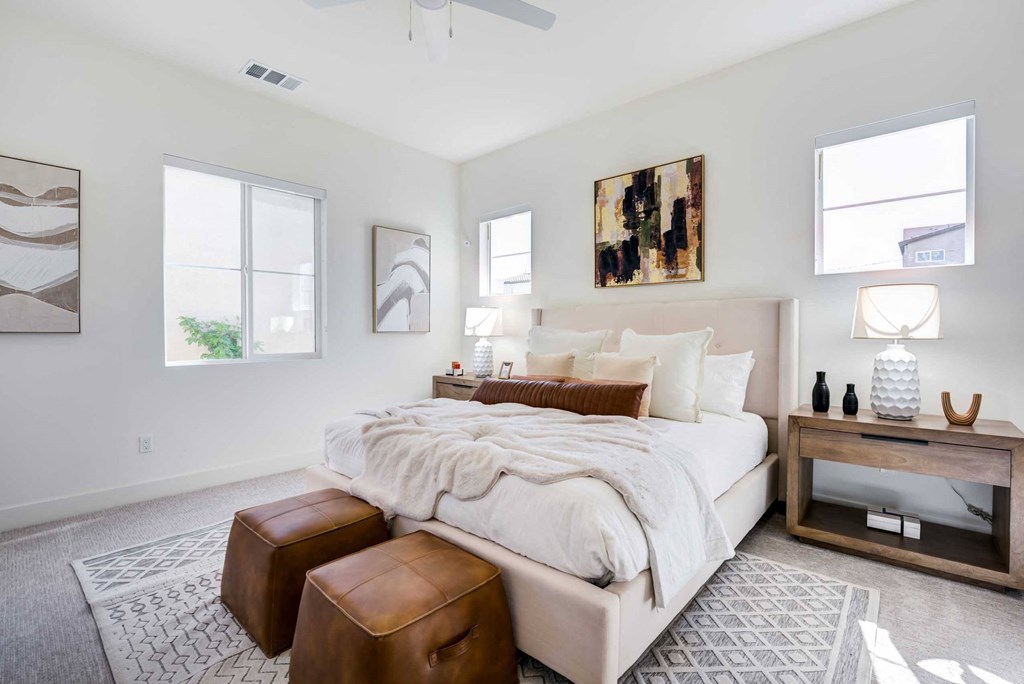 a bedroom with a bed and two windows