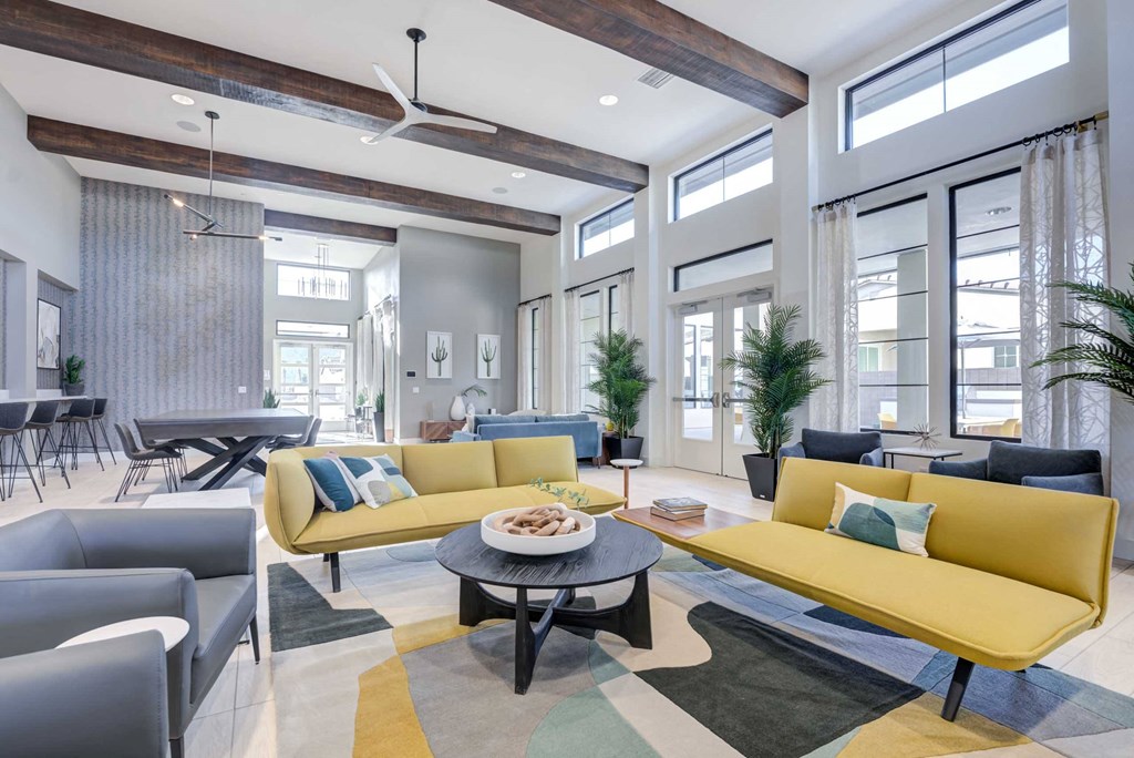 a living room with yellow couches and a table