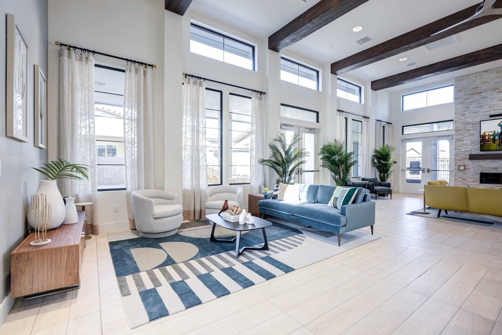 a living room with a blue couch and a rug
