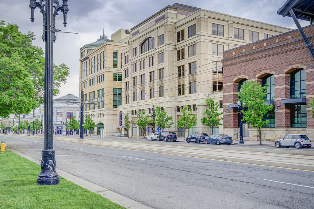 a city street with a large building on the corner of a street