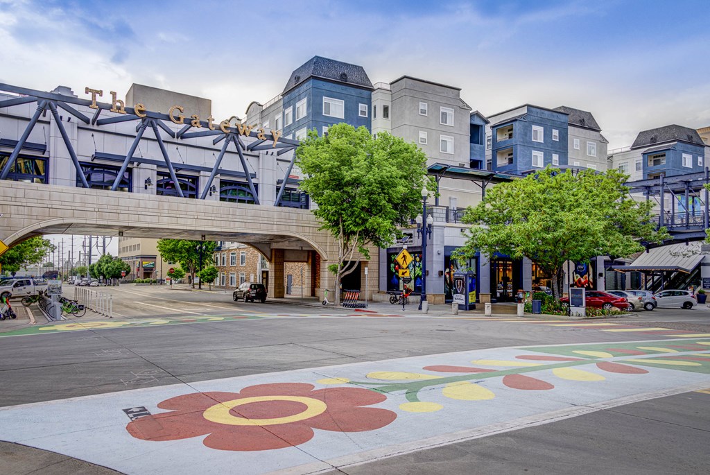 a city street with buildings and a sign on the ground