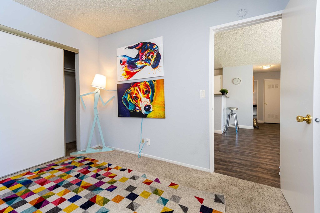a bedroom with a bed and a painting on the wall