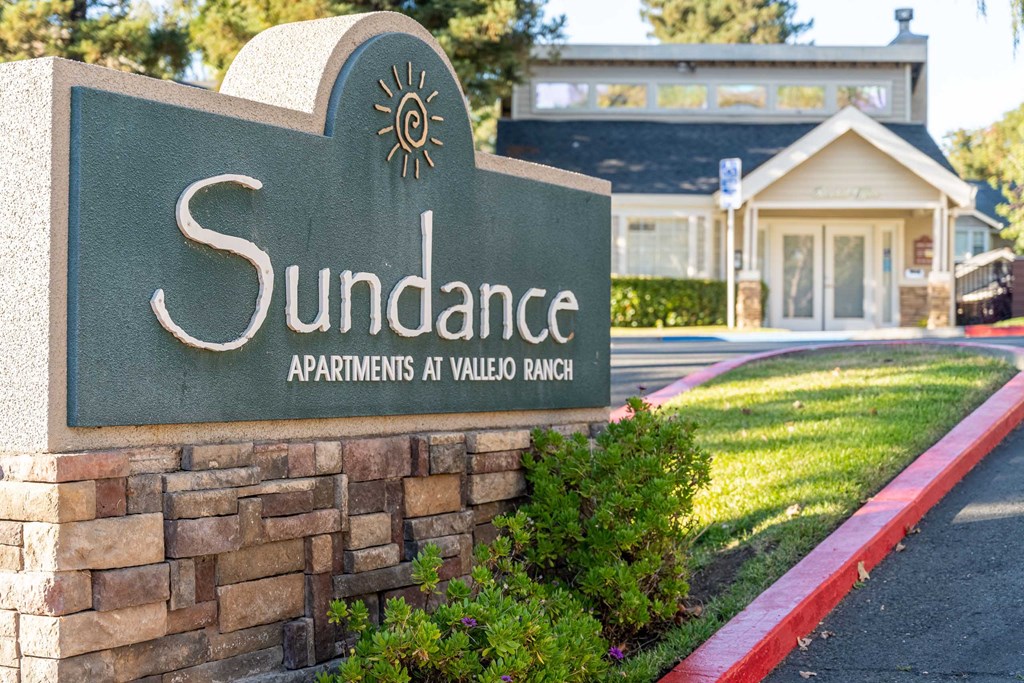 a stone monument sign for the sundance apartments at villas at valley blvd