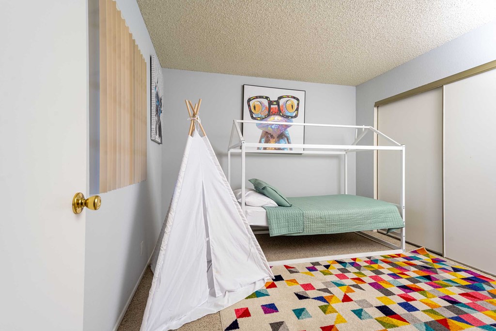 a bedroom with a bed and a tent