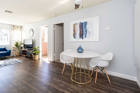 a dining room with a white table and chairs