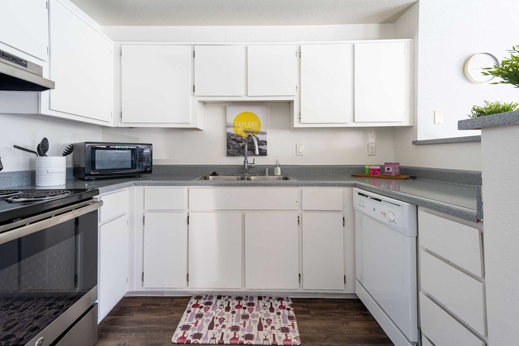 a kitchen with white cabinets and a sink