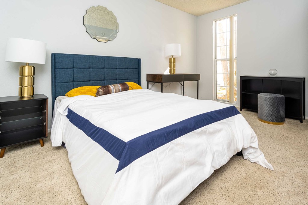 a bedroom with a bed and two night stands