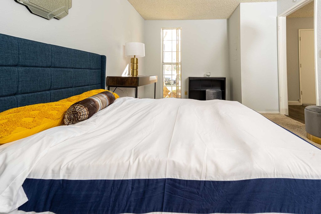 a bedroom with a large bed and a fireplace