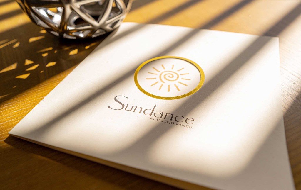 a napkin with a sun dance logo on a table
