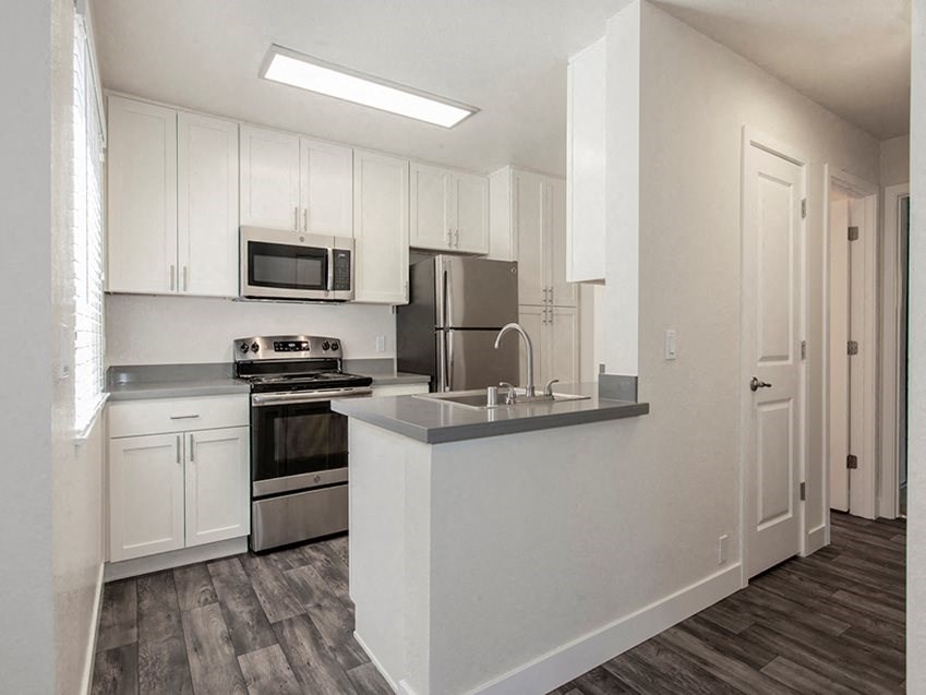 a kitchen with white cabinets and a counter top