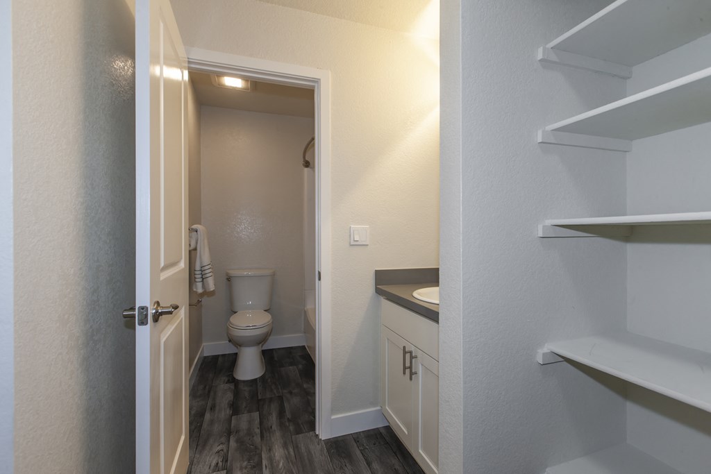 a bathroom with a toilet and a sink and a doorway