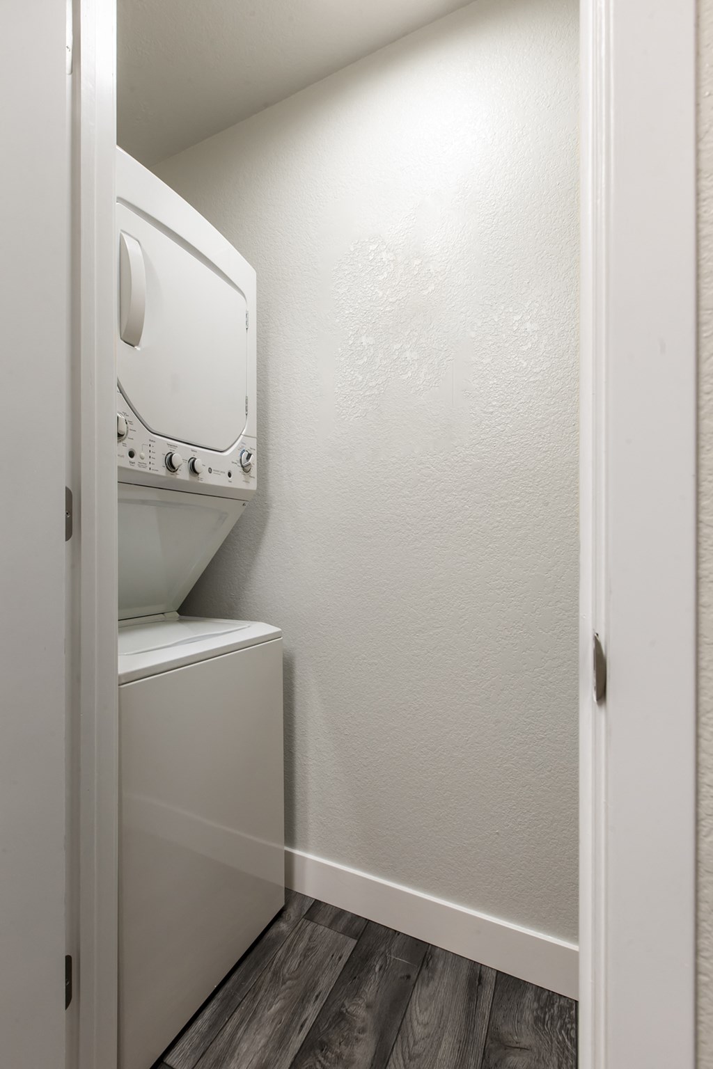 a laundry room with a washer and dryer and a door to a closet