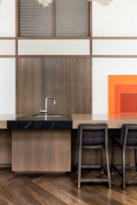 A kitchen with a black counter top and wooden cabinets.