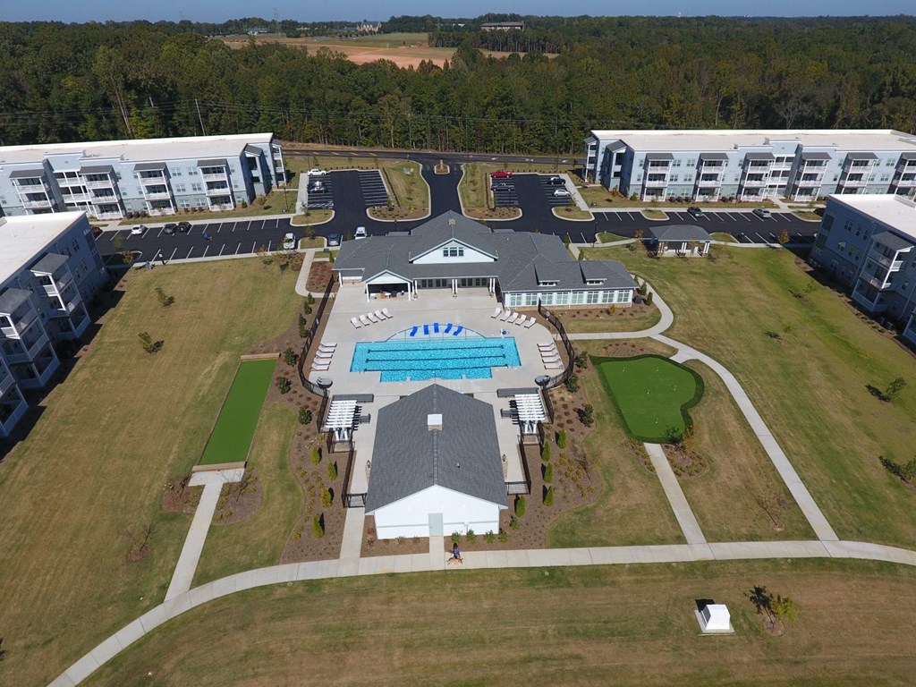 an aerial view of a resort with buildings and a pool