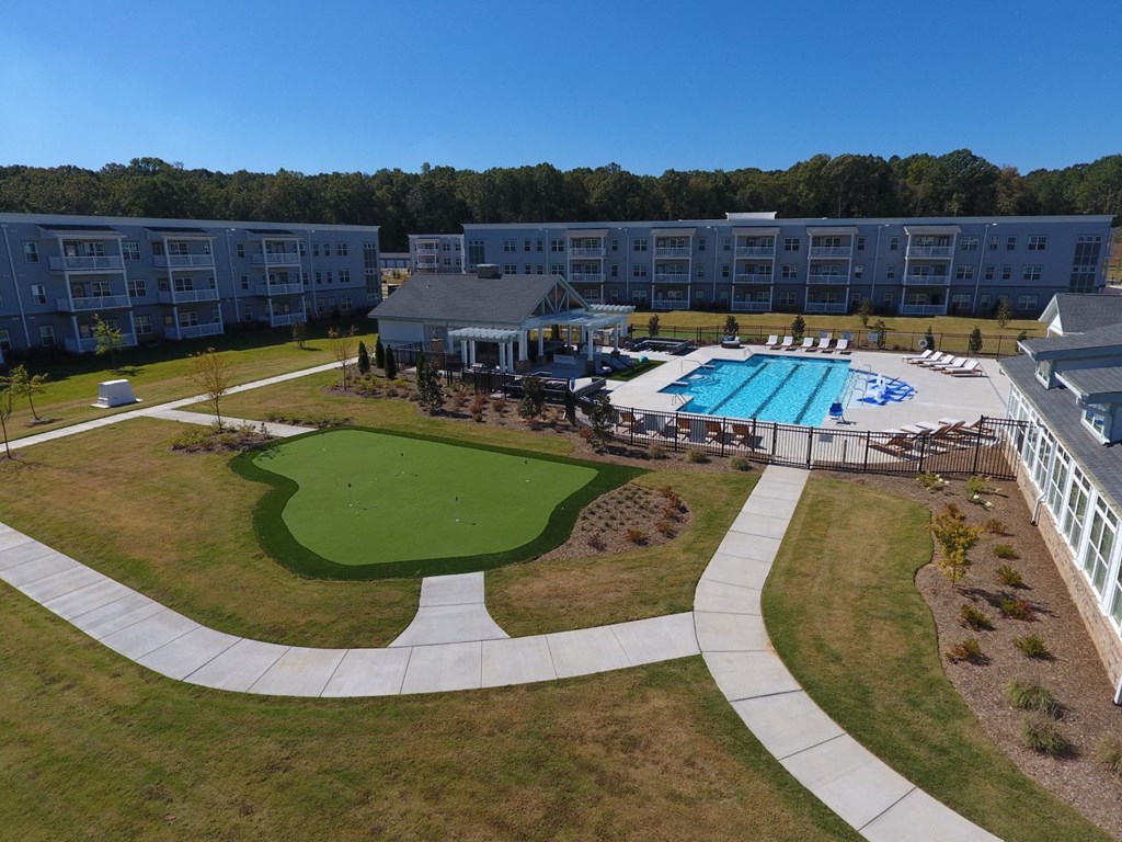 an aerial view of a resort with a pool and a golf course