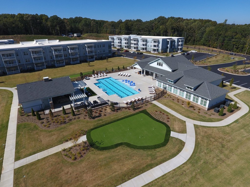 an aerial view of a resort with a swimming pool