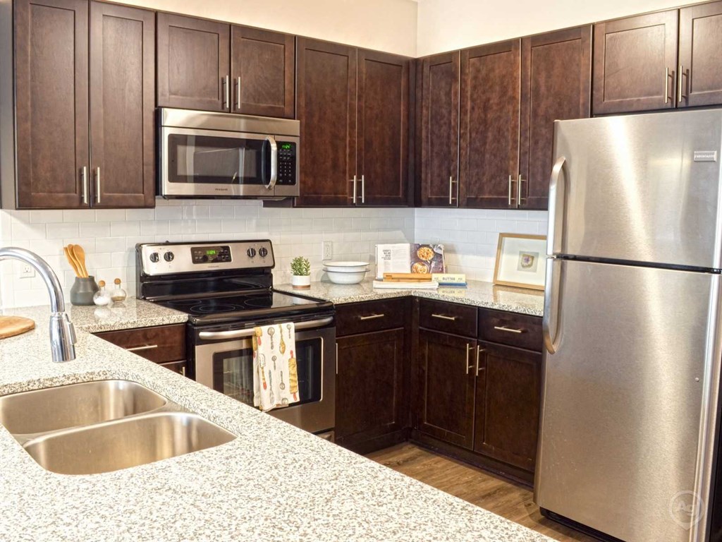 a kitchen with stainless steel appliances and wooden cabinets