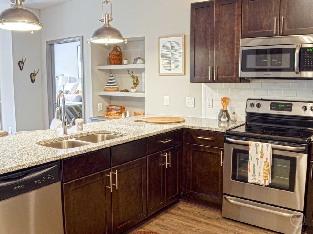 a kitchen with stainless steel appliances and granite counter tops