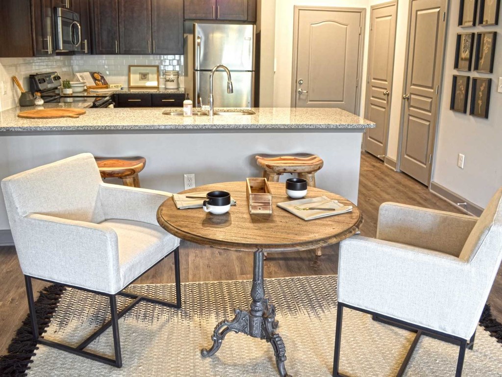 a kitchen with a table and chairs in front of a counter