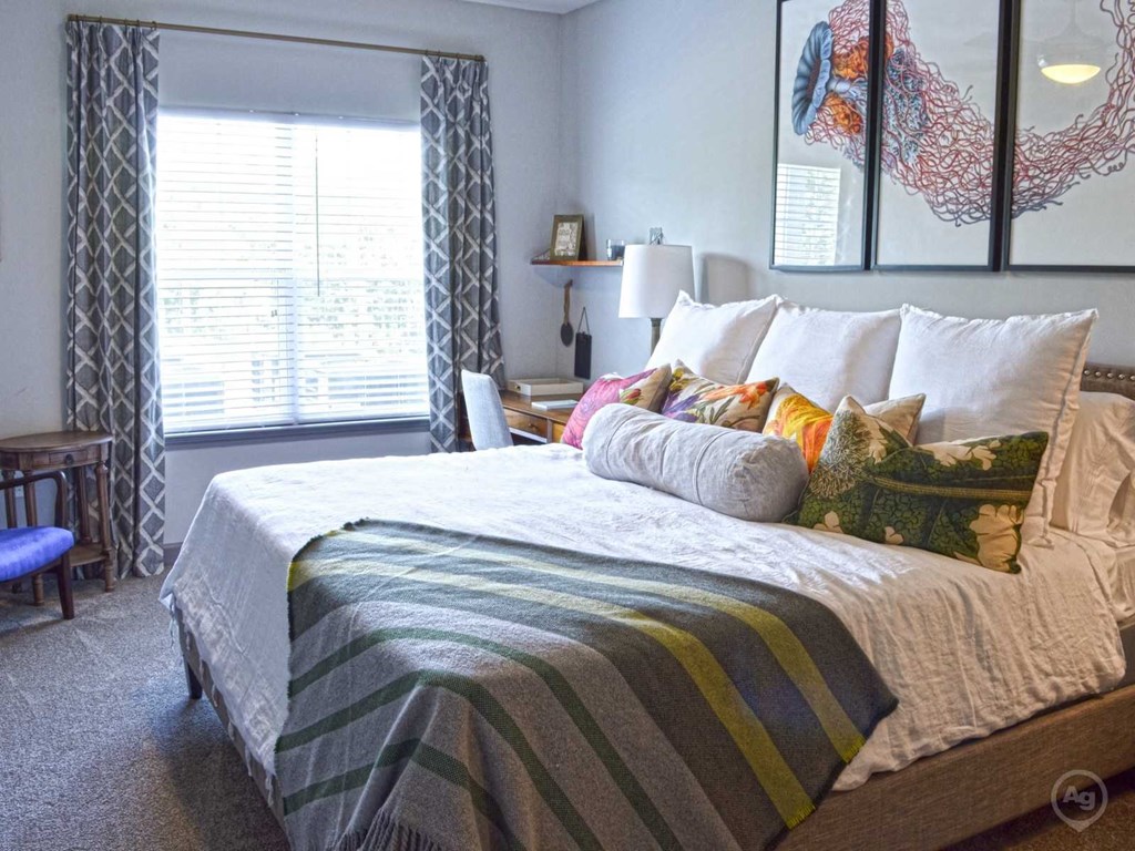 a bedroom with a bed and some pillows on it