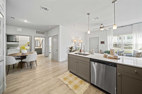 A modern kitchen with a dining table and chairs.