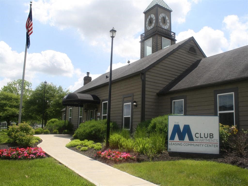 the building is shown with a sign and a clock tower