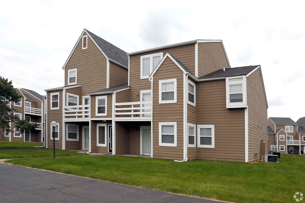 a row of houses with brown roofs and white windows