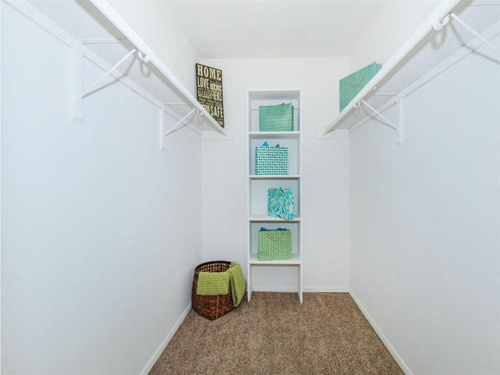 a closet with shelves and a basket on the floor