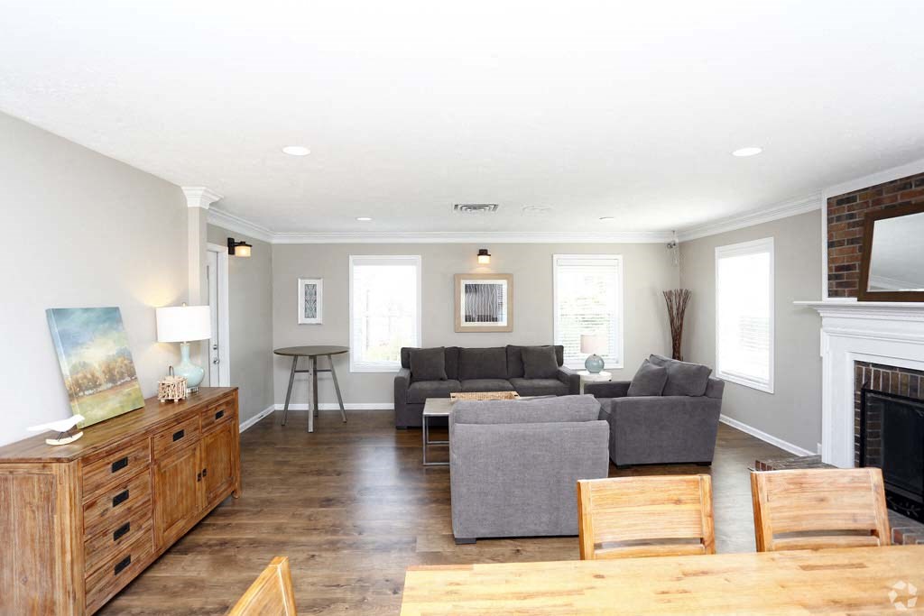 a living room with couches and a table and a fireplace