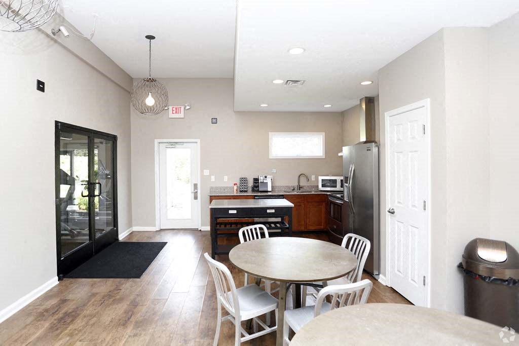 a kitchen and dining room with a table and a refrigerator