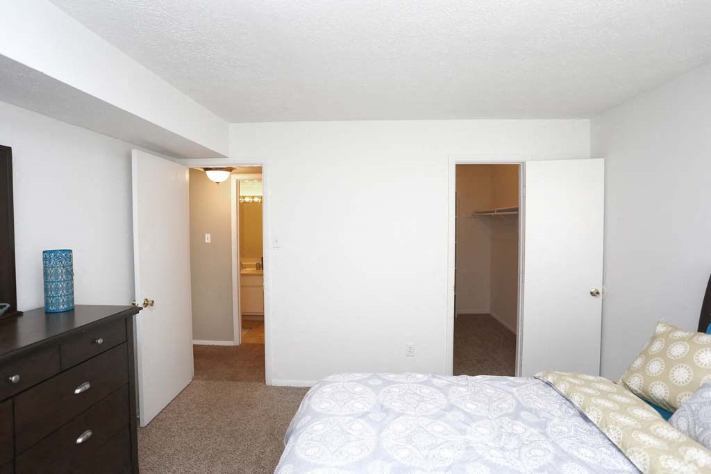 a bedroom with a bed and a closet