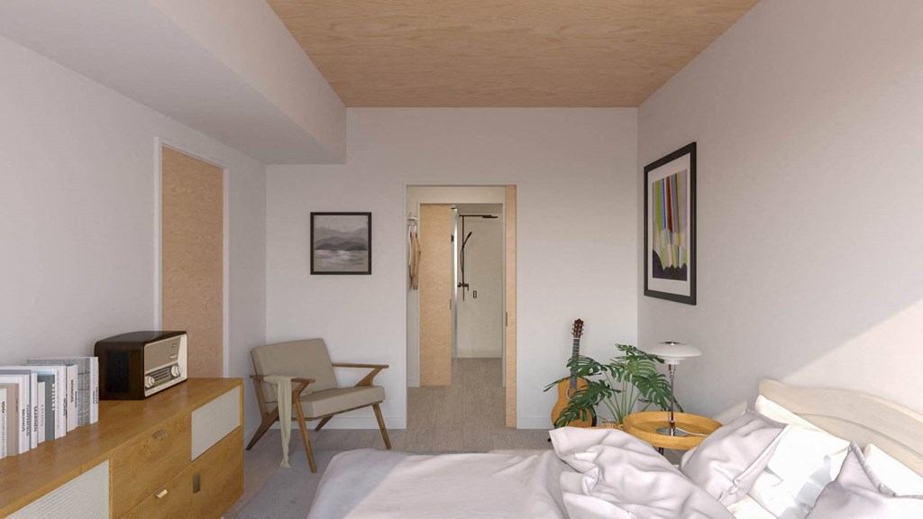 a bedroom with a bed and a desk and a chair