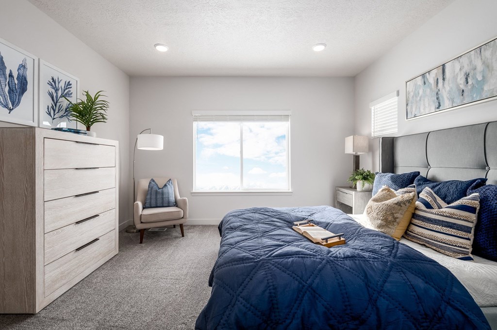 a bedroom with a bed and a dresser