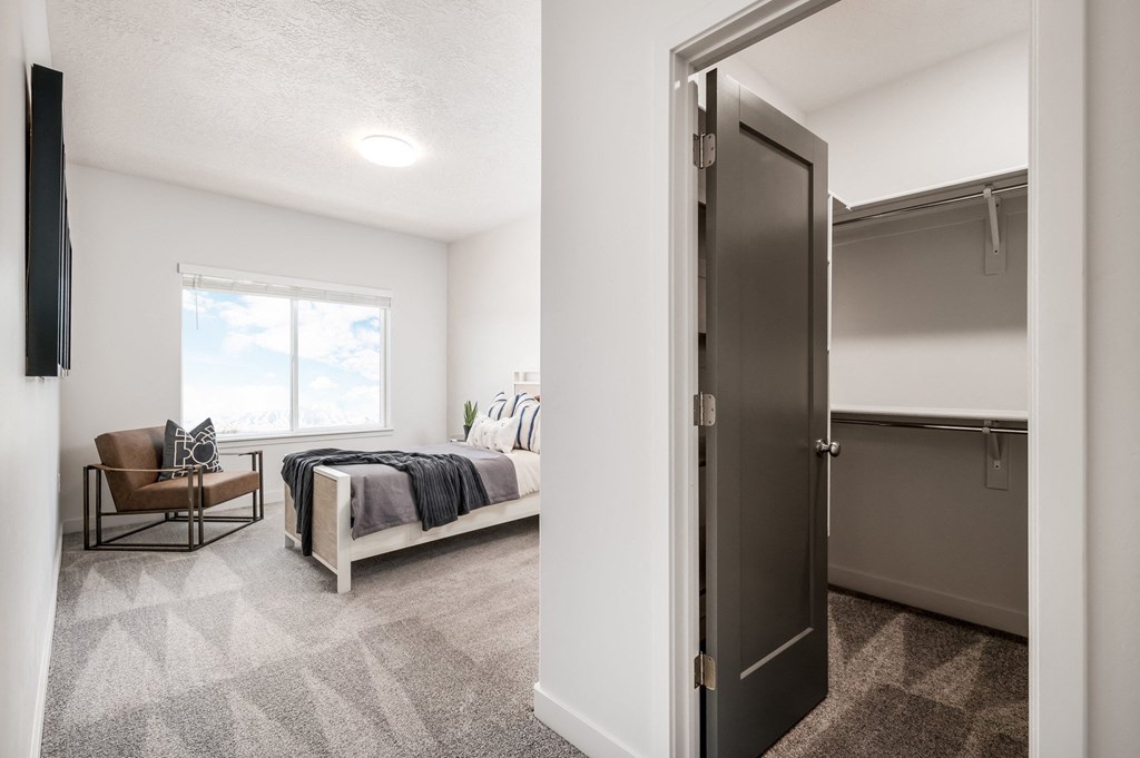 a bedroom with a bed and a closet with a sliding door