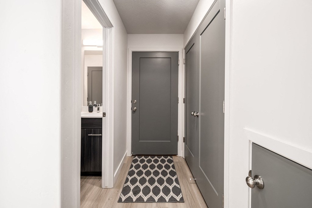 a view of a hallway with a door to a bathroom and a closet